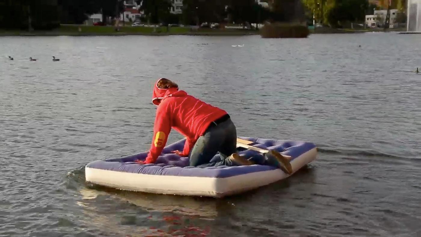 A video still from the project: on an air mattress in Echo Park Lake.